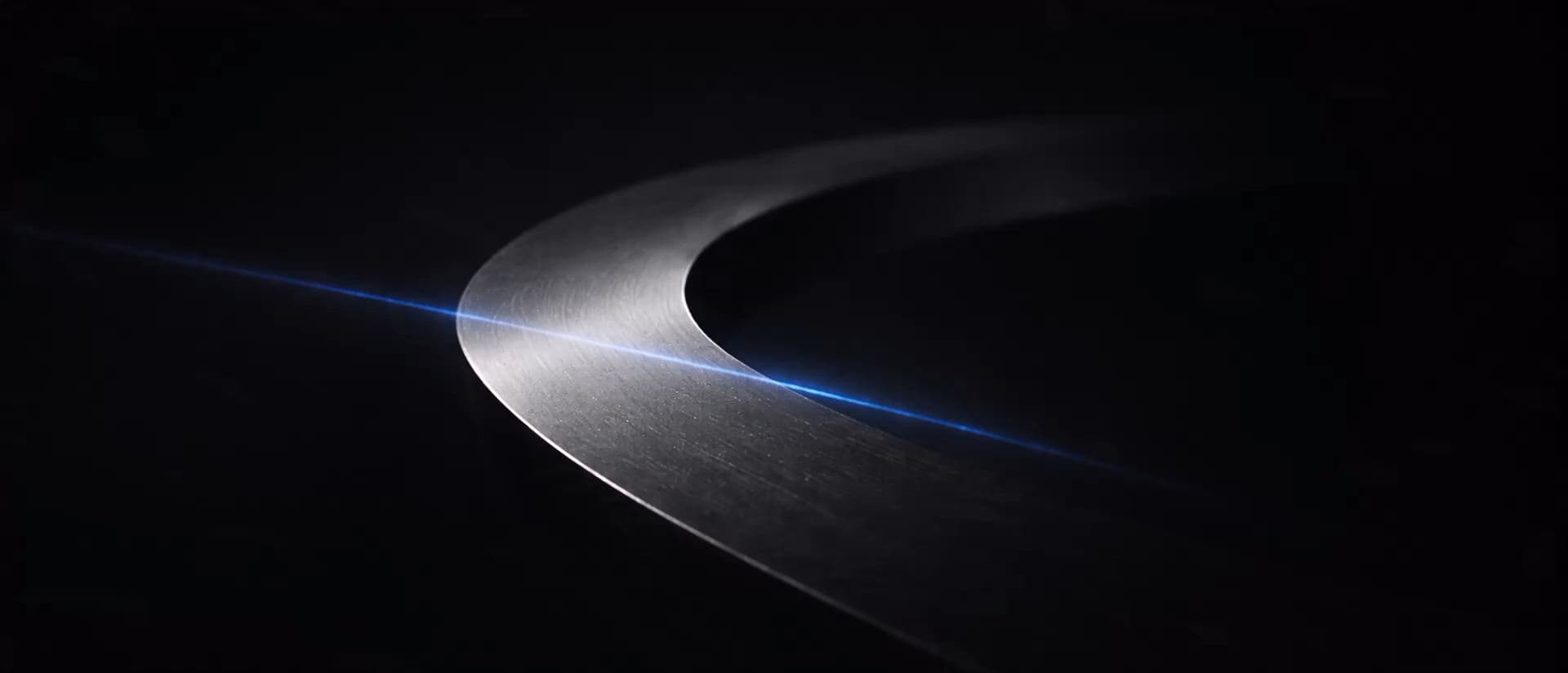Abstract brushed-metal forms resolving into the MAXI Strategic Technologies wordmark.